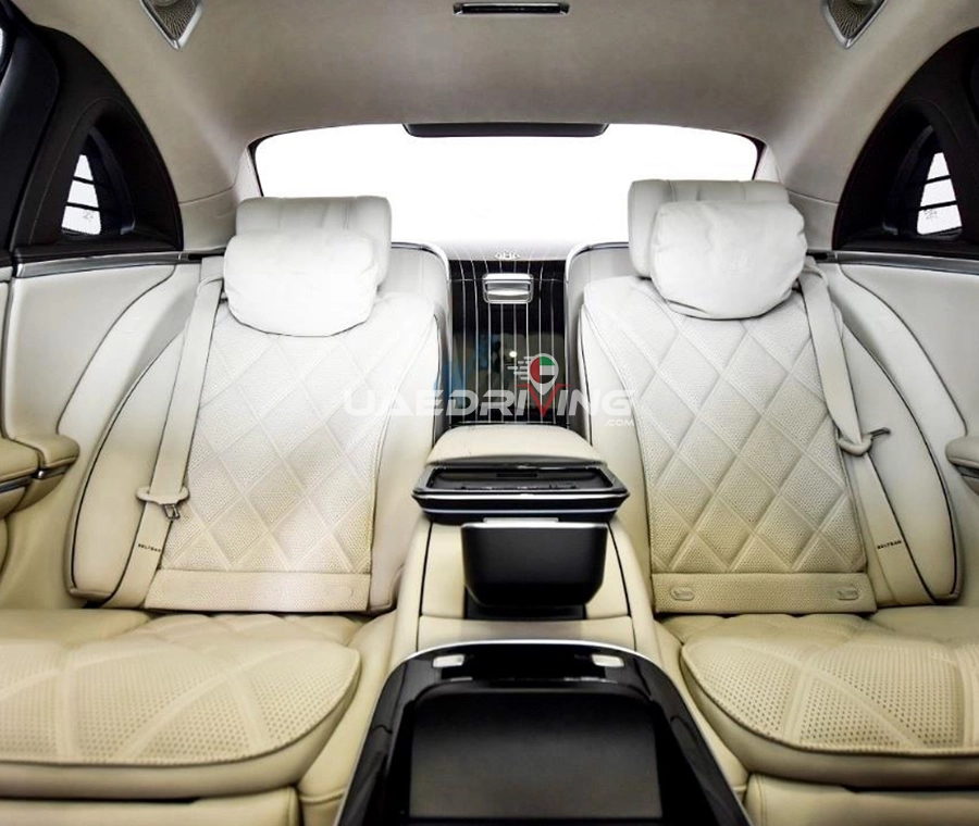 Luxurious car cabin of Mercedes Benz Maybach with exquisite leather seating and prominent display of high-tech amenities.