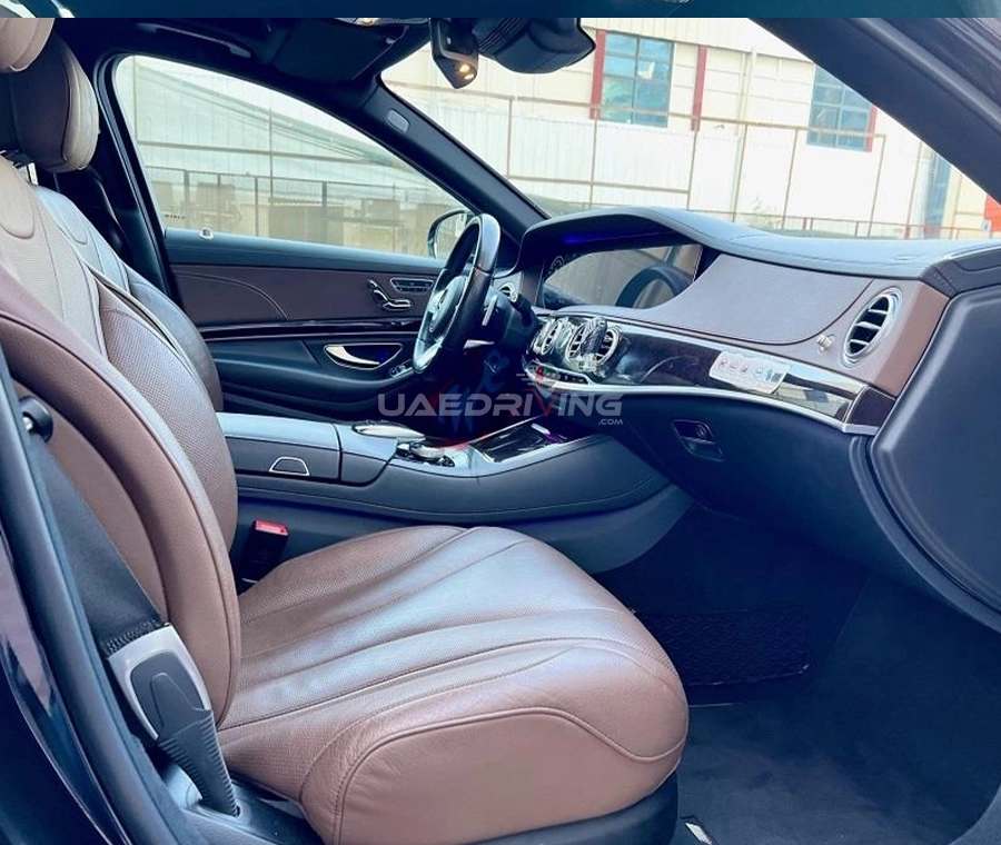 Interior view of a black Mercedes Benz S Class car featuring plush leather seats and a sleek steering wheel