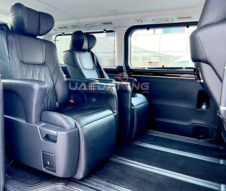 Luxurious car cabin of Toyota Granvia showcasing plush leather seats, a sleek dashboard, and cutting-edge technological features.