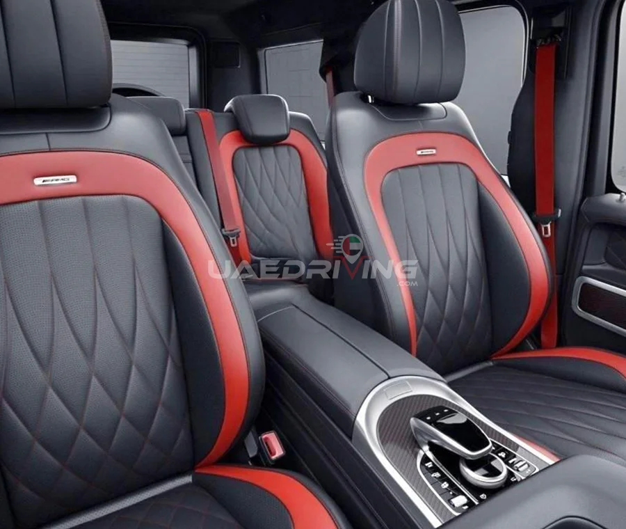 Luxurious interior of Mercedes Benz G 63 car featuring a stylish combination of red and black leather seats