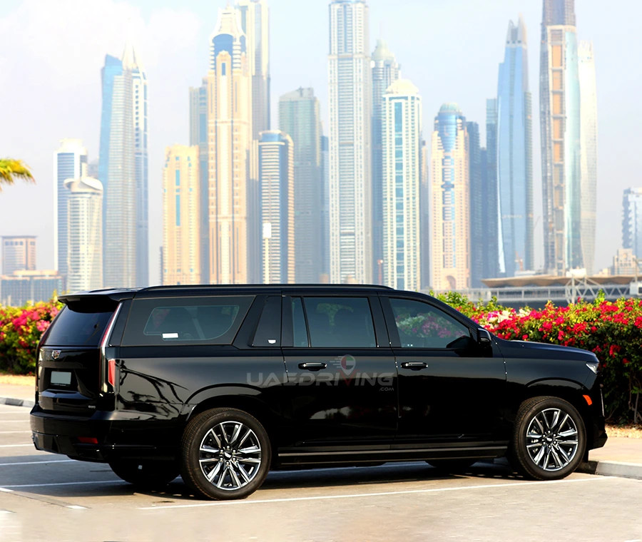 A image of a black Cadillac Escalade car highlighting its sophisticated design and sleek lines against the cityscape.