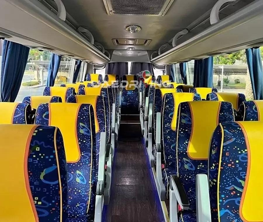 Interior of King Long 35 Seater bus showcasing its vibrant yellow and blue seats, emphasizing the distinct color scheme.