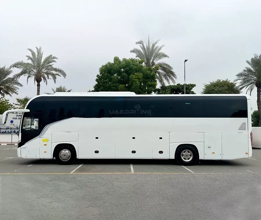 Side view of a white Yutong 53 Seater bus featuring tinted windows and a sleek design